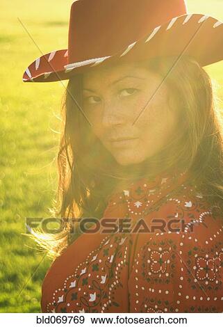 Woman wearing cowboy hat in sunlight View Large Photo Image Stock Photo - Woman wearing cowboy hat in sunlight. Fotosearch