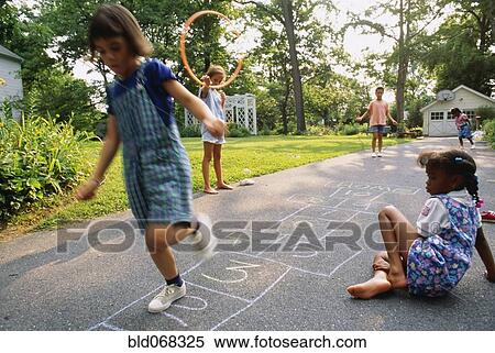 Stock Photography - Young girls playing hopscotch. Fotosearch