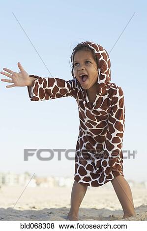 Young mixed race girl gesturing on beach wearing hoody View Large Photo Image Stock Photo - Young mixed race girl gesturing on beach wearing hoody. Fotosearch