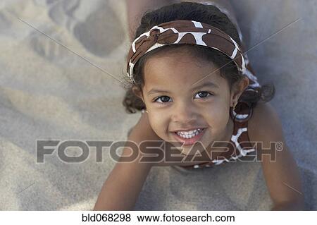Young mixed race girl looking up at beach View Large Photo Image Stock Photo - Young mixed race girl looking up at beach. Fotosearch
