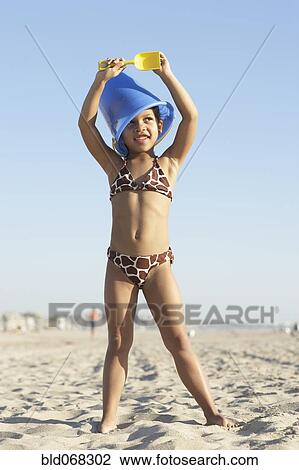 Young mixed race girl playing at beach View Large Photo Image Stock Image - Young mixed race girl playing at beach. Fotosearch