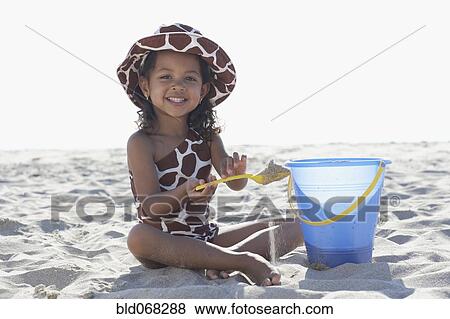 Stock Photo - Young mixed race girl playing at beach. Fotosearch