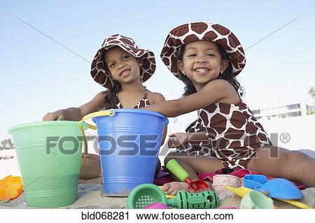 Young mixed race girls playing at beach View Large Photo Image Stock Image - Young mixed race girls playing at beach. Fotosearch