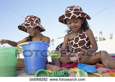 Stock Image - Young mixed race girls playing at beach. Fotosearch