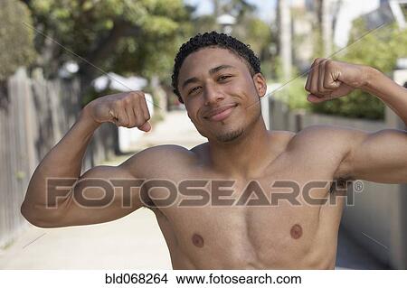 Young mixed race man with bare chest showing muscles View Large Photo Image Picture - Young mixed race man with bare chest showing muscles. Fotosearch