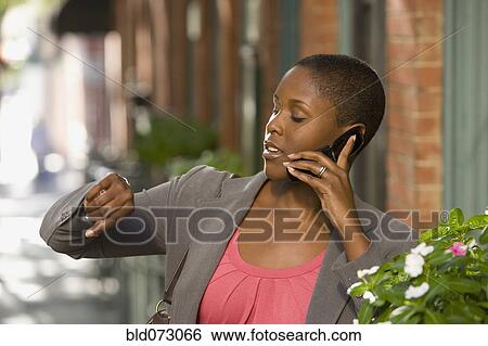 African businesswoman talking on cell phone outdoors View Large Photo Image Stock Photograph - African businesswoman talking on cell phone outdoors. Fotosearch