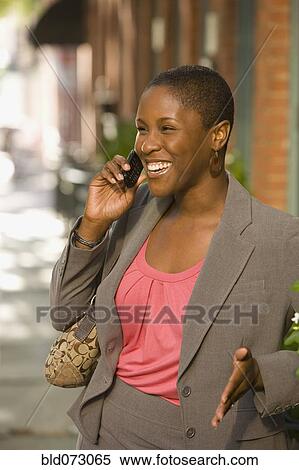 African businesswoman talking on cell phone outdoors View Large Photo Image Stock Photography - African businesswoman talking on cell phone outdoors. Fotosearch