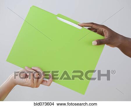 African woman handing co-worker a folder View Large Photo Image Picture - African woman handing co-worker a folder. Fotosearch