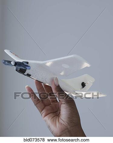 African woman holding airplane model View Large Photo Image Stock Photo - African woman holding airplane model. Fotosearch