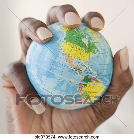 African woman holding globe in hand View Large Photo Image Picture - African woman holding globe in hand. Fotosearch
