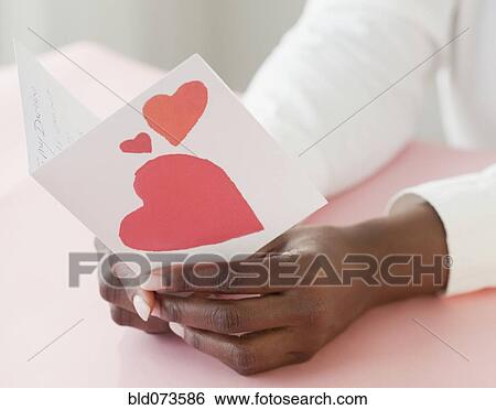 African woman holding Valentine’s Day card View Large Photo Image Stock Photograph - African woman holding Valentine’s Day card. Fotosearch