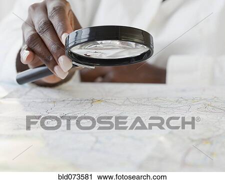 African woman using magnifying glass on map View Large Photo Image Stock Image - African woman using magnifying glass on map. Fotosearch