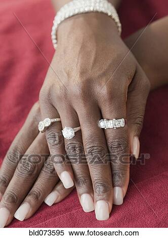Stock Photography - African woman wearing many diamond rings. Fotosearch