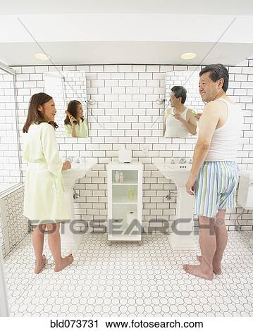 Stock Image - Asian husband and wife in bathroom together. Fotosearch