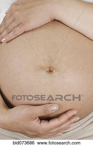 Close up of Chinese woman’s pregnant stomach View Large Photo Image Stock Photograph - Close up of Chinese woman’s pregnant stomach. Fotosearch