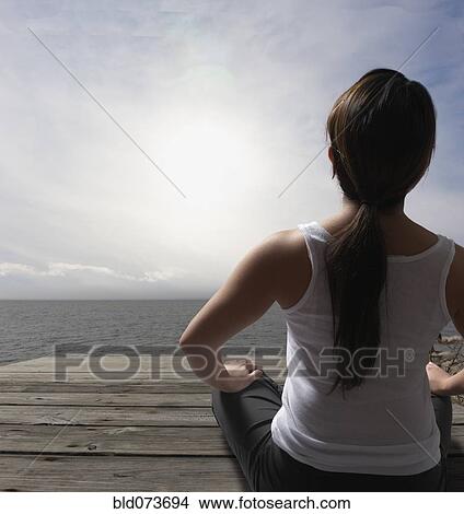 Filipino woman sitting on dock near ocean View Large Photo Image Picture - Filipino woman sitting on dock near ocean. Fotosearch