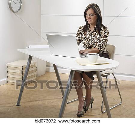 Hispanic businesswoman working at laptop in office View Large Photo Image Stock Image - Hispanic businesswoman working at laptop in office. Fotosearch