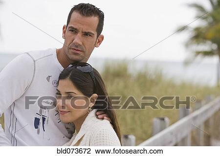 Hispanic couple hugging near ocean View Large Photo Image Stock Image - Hispanic couple hugging near ocean. Fotosearch