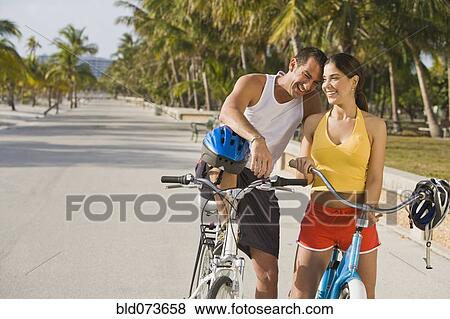Hispanic couple on bicycles taking rest break View Large Photo Image Stock Photo - Hispanic couple on bicycles taking rest break. Fotosearch