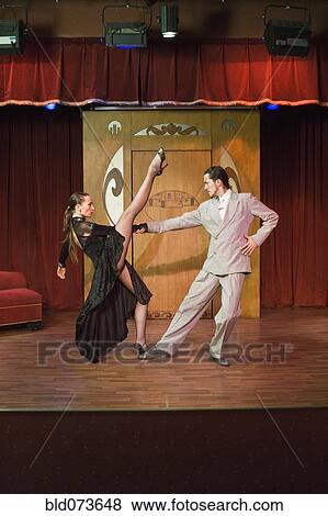 Hispanic couple performing tango on stage View Large Photo Image Stock Photo - Hispanic couple performing tango on stage. Fotosearch