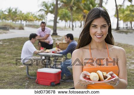 Stock Photo - Hispanic friends enjoying barbecue. Fotosearch