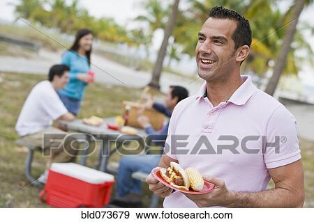 Hispanic friends enjoying barbecue View Large Photo Image Stock Photo - Hispanic friends enjoying barbecue. Fotosearch