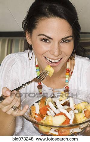 Hispanic woman eating healthy salad View Large Photo Image Stock Photo - Hispanic woman eating healthy salad. Fotosearch