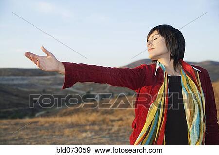 Stock Photo - Hispanic woman enjoying the outdoors. Fotosearch