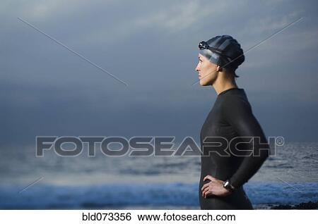 Hispanic woman in wetsuit on beach View Large Photo Image Stock Photograph - Hispanic woman in wetsuit on beach. Fotosearch