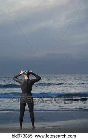 Hispanic woman in wetsuit on beach View Large Photo Image Stock Photography - Hispanic woman in wetsuit on beach. Fotosearch