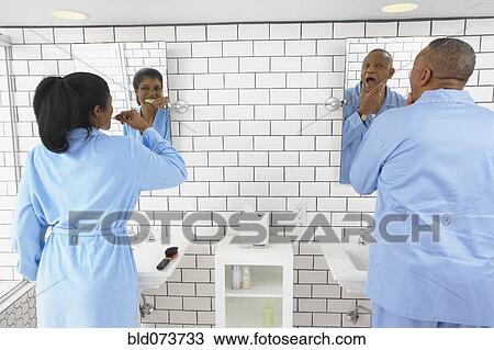 Husband and wife in bathroom together View Large Photo Image Stock Image - Husband and wife in bathroom together. Fotosearch