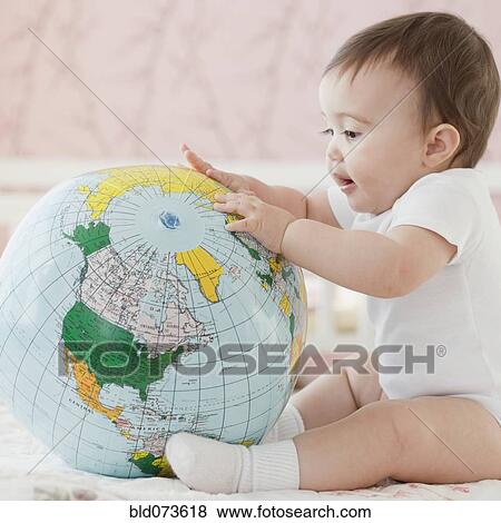 Mixed race baby girl looking at blow-up globe View Large Photo Image Stock Photo - Mixed race baby girl looking at blow-up globe. Fotosearch