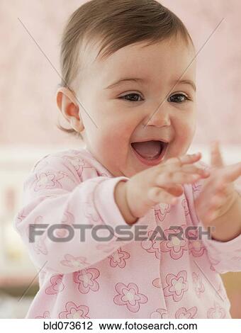Mixed race baby girl with hands out laughing View Large Photo Image Stock Image - Mixed race baby girl with hands out laughing. Fotosearch