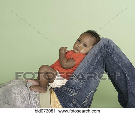 Mixed race mother holding baby daughter View Large Photo Image Stock Image - Mixed race mother holding baby daughter. Fotosearch