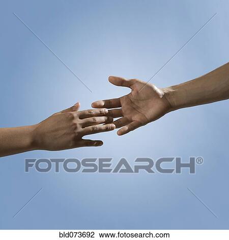 Mixed race people reaching out hands toward one another View Large Photo Image Stock Image - Mixed race people reaching out hands toward one another. Fotosearch
