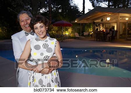 Multi-ethnic couple enjoying pool party View Large Photo Image Picture - Multi-ethnic couple enjoying pool party. Fotosearch