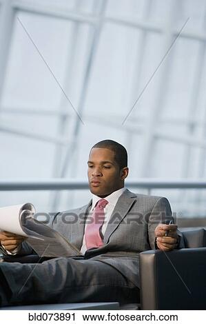 African businessman reviewing paperwork View Large Photo Image Stock Image - African businessman reviewing paperwork. Fotosearch