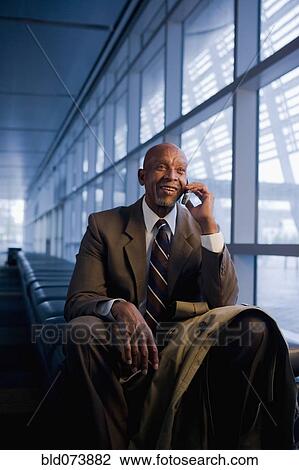 African businessman using cell phone View Large Photo Image Stock Image - African businessman using cell phone. Fotosearch