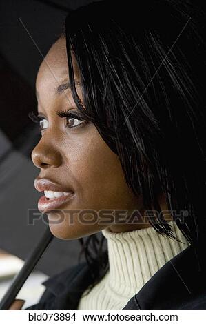 African businesswoman holding umbrella View Large Photo Image Picture - African businesswoman holding umbrella. Fotosearch