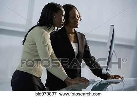 African businesswomen using computer View Large Photo Image Stock Photo - African businesswomen using computer. Fotosearch