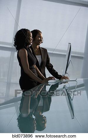 Stock Photograph - African businesswomen using computer. Fotosearch