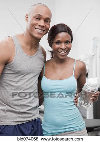 African couple hugging in health club View Large Photo Image Stock Photo - African couple hugging in health club. Fotosearch