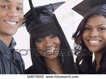 Stock Image - African friends in graduation cap and gown. Fotosearch