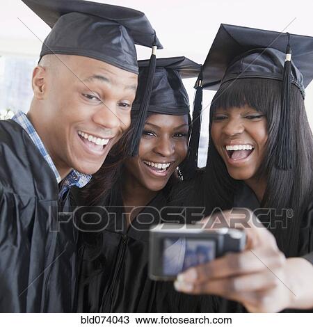 African friends in graduation cap and gown taking self-portrait View Large Photo Image Stock Image - African friends in graduation cap and gown taking self-portrait. Fotosearch