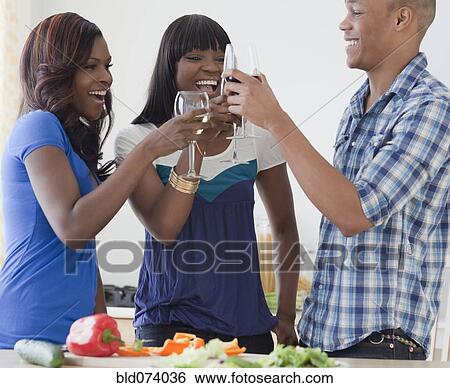 Stock Photograph - African friends toasting. Fotosearch