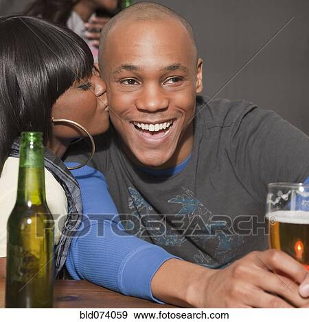 African woman kissing boyfriend in bar View Large Photo Image Stock Photo - African woman kissing boyfriend in bar. Fotosearch