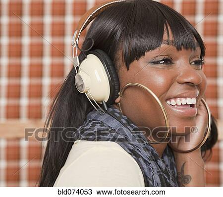 African woman listening to headphones View Large Photo Image Stock Image - African woman listening to headphones. Fotosearch
