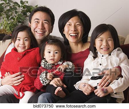 Stock Image - Asian family smiling together. Fotosearch