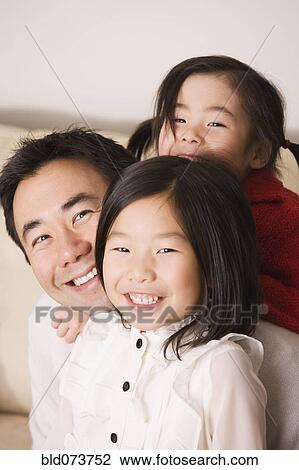 Asian father laughing with daughters View Large Photo Image Stock Image - Asian father laughing with daughters. Fotosearch