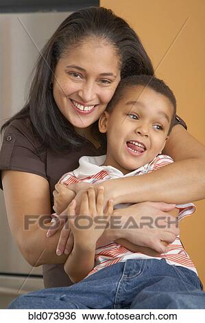 Dominican mother hugging son View Large Photo Image Stock Photograph - Dominican mother hugging son. Fotosearch